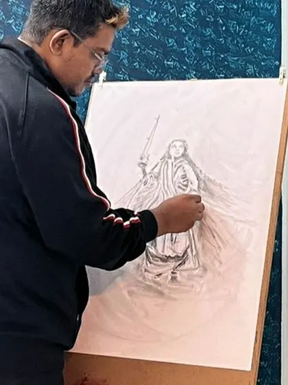 Here I am, working on a detailed graphite pencil drawing on an easel. In my classes, I guide students through the process of creating larger, more complex compositions.