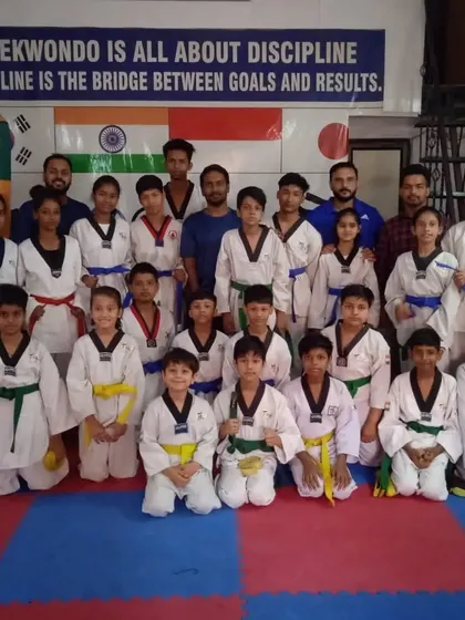 A proud group photo with the examiners after a successful belt promotion test. It's a day of celebration for the entire academy.