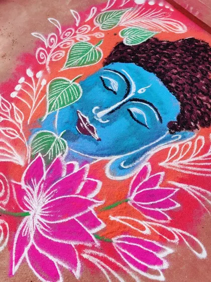 A serene Buddha face rangoli, surrounded by lotus flowers and Bodhi leaves. I used bright colors to create a peaceful and welcoming design.
