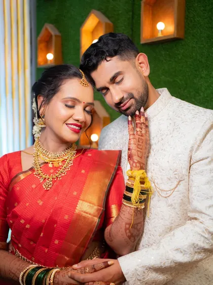 A tender moment between the bride and groom after their wedding ceremony, her hand gently resting on his chest.
