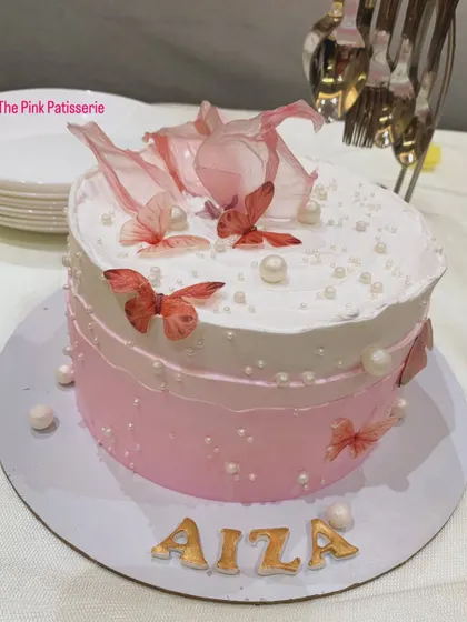 A pink ombre cake for Aiza, decorated with edible butterflies and pearls.
