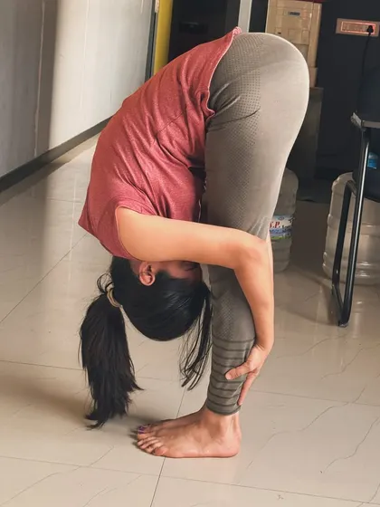 A standing forward bend, or Uttanasana, is a great yoga pose for stretching the hamstrings and releasing tension in the back.