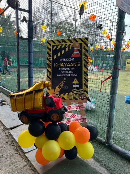 A welcome sign and a dump truck balloon arrangement greeted guests at the entrance of this fun-filled construction party.
