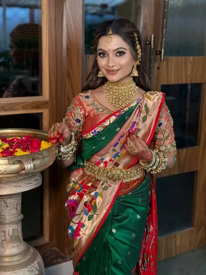 A stunning bride in a multi-colored Paithani saree, featuring a soft glam makeup look and traditional gold accessories.