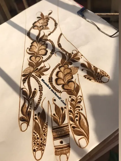 A Qatar/Dubai style design on a practice sheet, combining leaves and beaded chains.