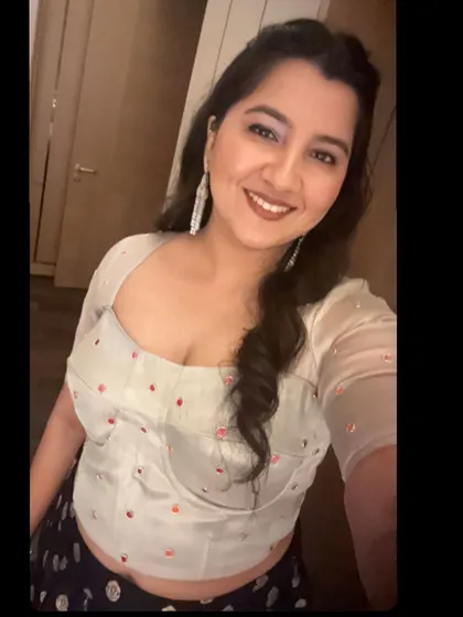 A close-up selfie showing the beautiful fit and detail of the custom-designed corset blouse, which features delicate beading and a sweetheart neckline.