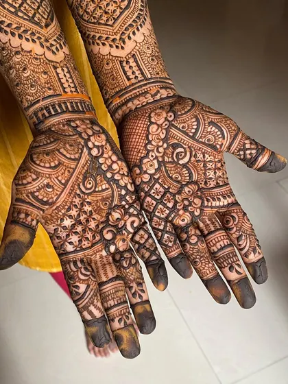 The palms of a full bridal mehendi, showcasing a dense and detailed design that is both traditional and timeless.