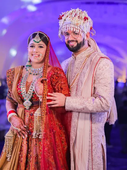 A happy portrait of the couple after their wedding ceremony. Their smiles and the bride's beautiful sehra create a classic and joyful wedding memory.