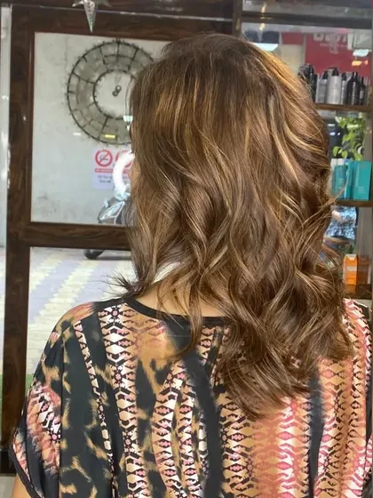 This shot captures the texture and movement of the hair. The combination of a good cut, expert color, and professional styling makes all the difference.