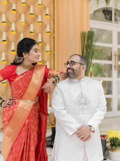A playful and confident portrait of the couple. The bride's pose adds a touch of fun and personality to the shot.
