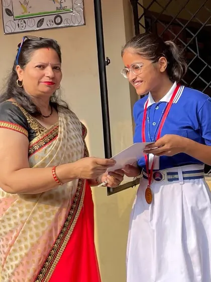 A teacher distributing certificates and medals to students after the Open National Taekwondo Championship. School support is crucial for a student's success.