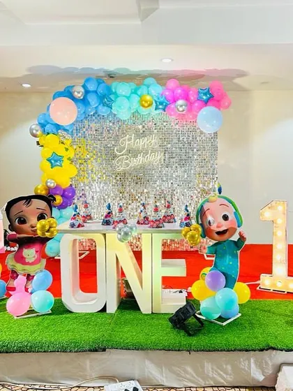 Another Cocomelon first birthday setup, this one featuring a silver shimmer wall and a budget-friendly design.