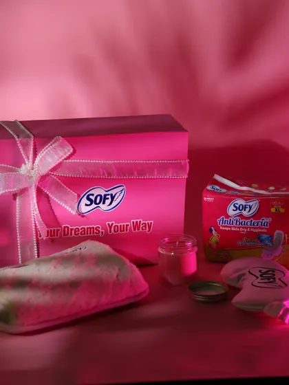 This beautifully lit shot captures the full Sofy hamper, including the branded box, eye mask, pouch, candle, and products.
