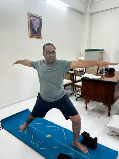 My client holds a strong Warrior II pose. This is a testament to his hard work in regaining strength and balance after years of limited movement due to Gout.
