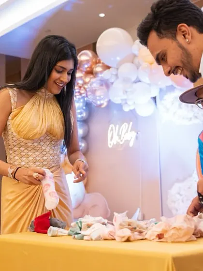 Another couple participating in the baby item guessing game.