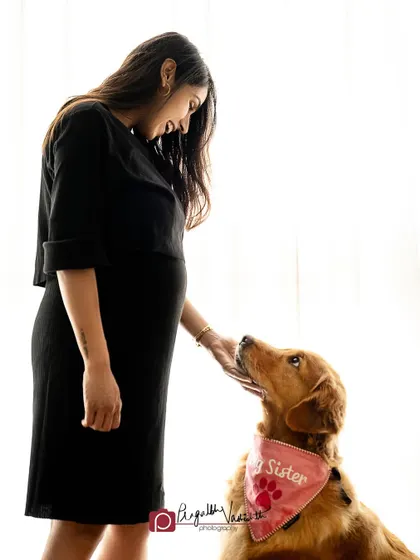 A tender moment between an expecting mother and her Golden Retriever. The high-key lighting creates a soft, ethereal mood perfect for a maternity session.