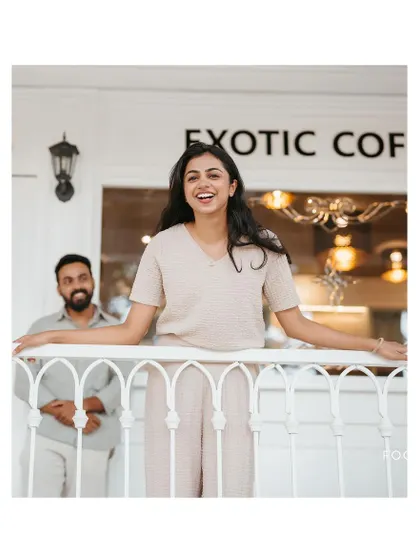 A duplicate of image 62, a bright and happy portrait of the bride-to-be on a cafe balcony.