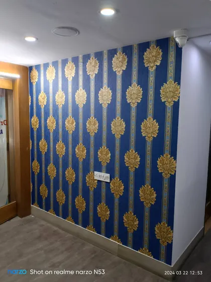 A clean, finished look of the blue and gold wallpaper in the office.