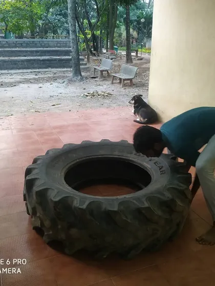 A moment of preparation before a heavy tire lift.