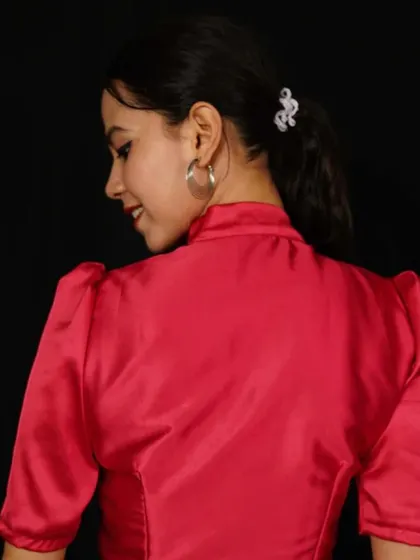 A bright red satin blouse with a high neck and puffed sleeves.