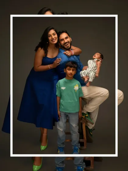 Another joyful pose from the same family of four, showcasing their fun-loving connection in a classic studio setting.