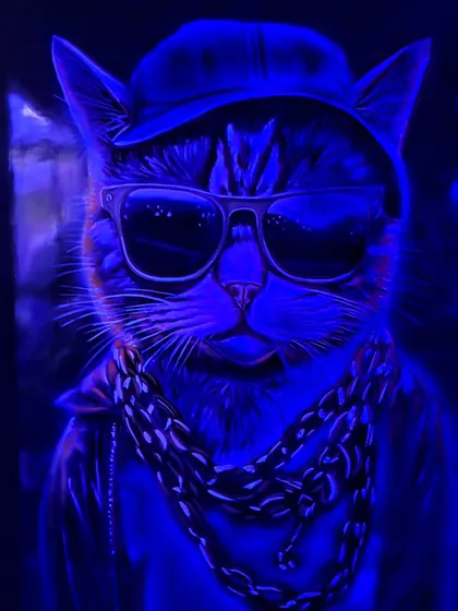 The same cat mural viewed under blue UV light, revealing a different mood and highlighting specific colors.