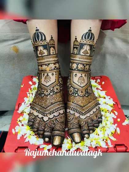 A grand foot design with palace architecture and jhumkis, surrounded by fresh flowers.