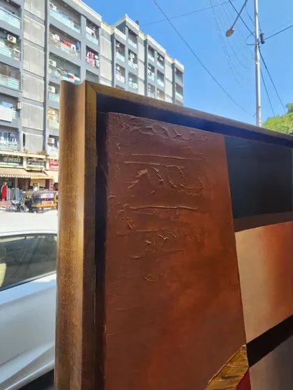A side view of the large canvas as it's being prepared for transport. You can see the thickness of the frame and the textured details along the edge, giving a sense of the painting's substantial presence.