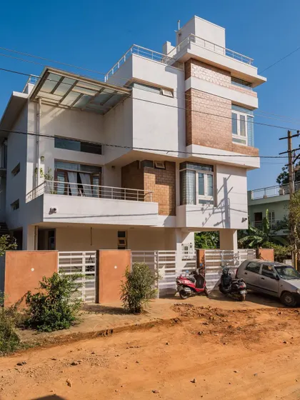 The exterior of Anand and Madhu's home in Bangalore. This project demonstrates how sustainable materials like mud blocks can be integrated into a contemporary, multi-level urban residence.
