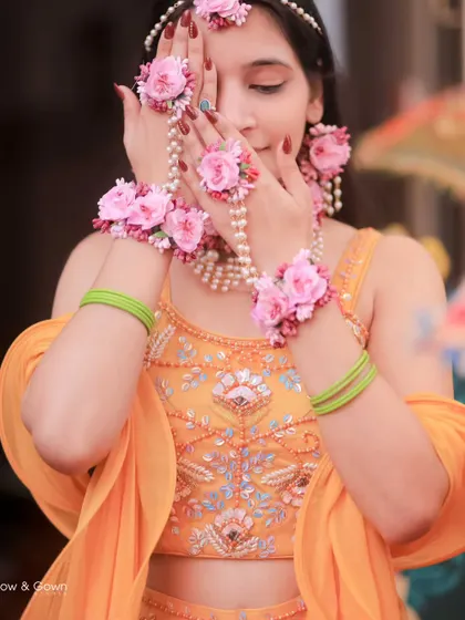 A lovely close-up of the bride with her floral jewellery. Her gentle expression and the beautiful details make this a stunning Haldi portrait.