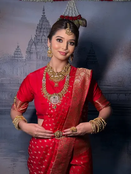 A beautiful portrait of the bride, with the saree draped to frame her face and highlight her traditional jewellery.