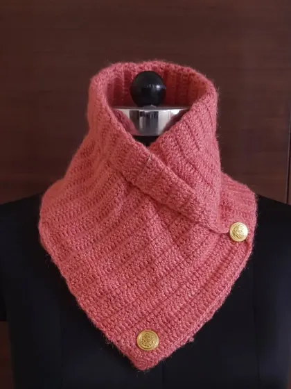 This lovely coral-pink crochet neck warmer adds a pop of color to grey winter days. It's handcrafted from soft wool to feel gentle against your skin.