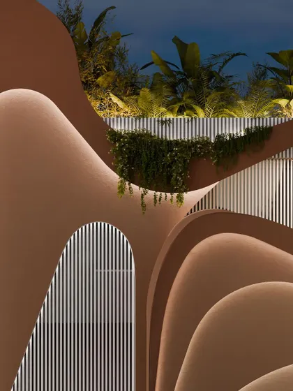 A detail of the upper levels of the facade, where the curves and textures create a rich, tactile surface.