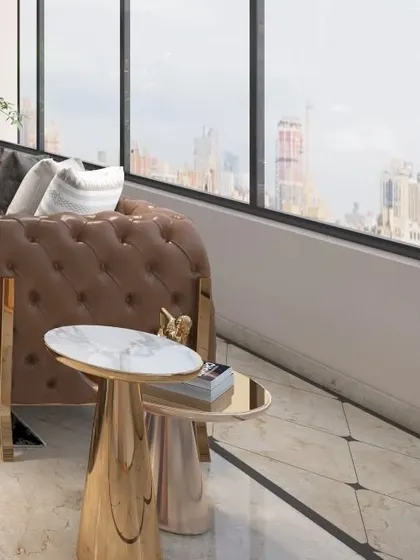 A close-up of the lounge seating next to the large windows, emphasizing the connection between the luxurious interior and the expansive city view outside.