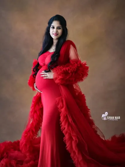 A stunning full-length portrait in a dramatic red ruffled gown. Our studio is equipped to capture the full effect of these elaborate dresses.