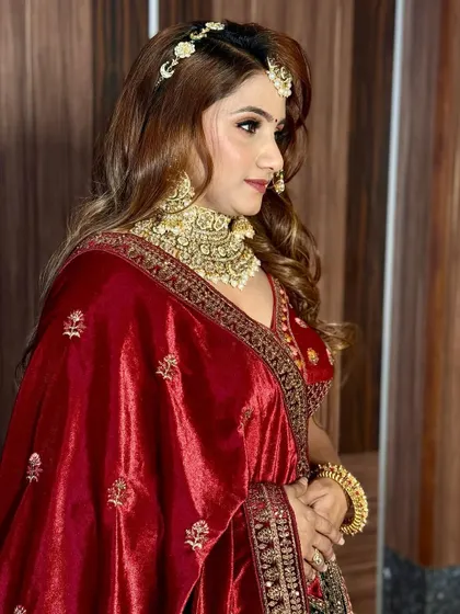 A side view of the complete reception look. The rich red velvet, the heavy jewelry, and the glamorous makeup all come together for a truly royal vibe.
