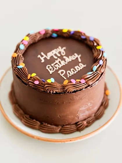 Nothing beats the timeless joy of a simple, classic chocolate cake for a birthday. This one is rich, moist, and decorated with fun, colorful sprinkles.