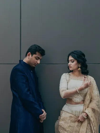A quiet, intimate moment between the couple. Her makeup is soft and romantic, designed to look flawless up close and in candid shots.