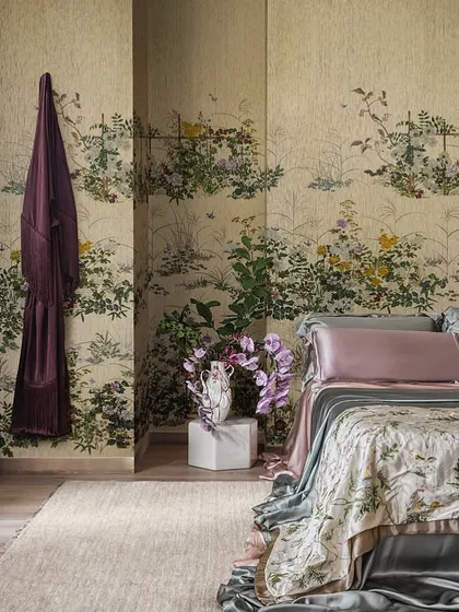 A bedroom enveloped in the 'Scenic Flora' wallpaper. Inspired by vintage embroidered kimonos and 17th-century Japanese chinoiseries, the theatrical composition invites you to explore its beauty from multiple perspectives.