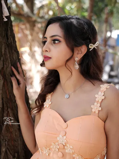 A close-up of the peach gown. The combination of the sweet color, floral details, and modern cut makes this a very special piece.
