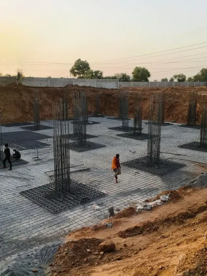 Construction is underway at AWE India School in Rajasthan. This image shows the foundation work, with rebar cages for the columns marking the first transition from design drawings to physical reality.