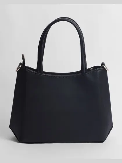 A clean shot of the back of a black women's handbag. We provide a complete set of images for every product.