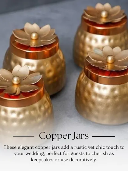 These elegant copper jars with floral lids add a rustic yet chic touch to your wedding. They are perfect for guests to use as decorative keepsakes long after the celebration.