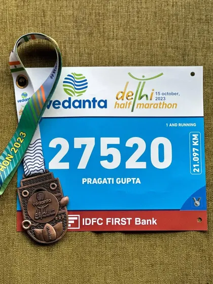 The bib and medal from the Vedanta Delhi Half Marathon. A reminder of a tough but rewarding race where I ran with 60-70% effort due to health issues but still finished strong.