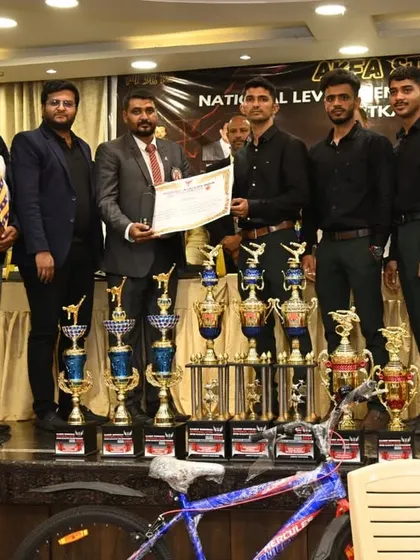 The spoils of victory. The organizing team stands proudly behind a table laden with trophies for the winners of the AKFA Strike 1 championship.