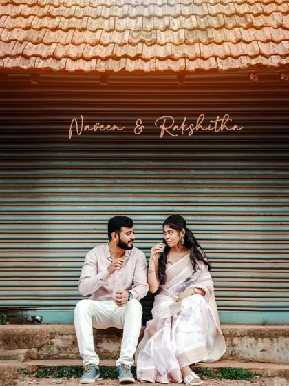 A vintage-style pre-wedding photo of a couple sitting on a step in front of a closed shop, creating a nostalgic and charming scene.