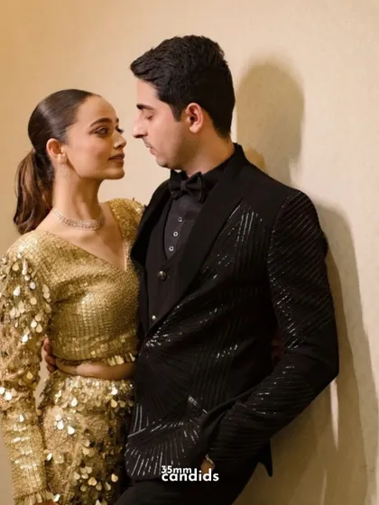 A classic, elegant portrait of the couple dressed in their glamorous reception outfits, ready for a night of celebration.