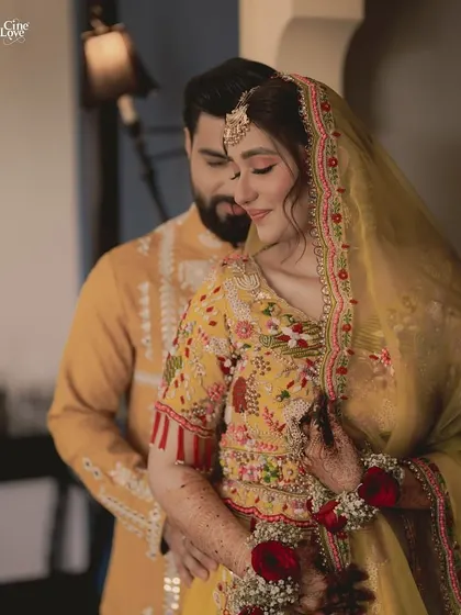 A close-up of the couple, showing the beautiful details of the bride's floral jewellery and the groom's embroidered kurta.