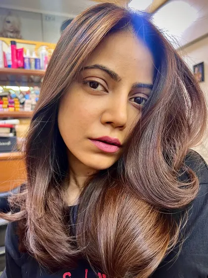 The finished caramel balayage, styled with soft waves. The color melt is seamless, creating a rich and dimensional look.