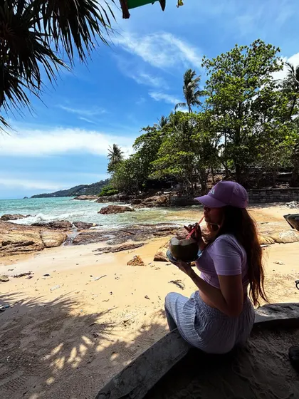 Sipping on fresh coconut water at Patong Beach, Phuket. A classic tropical vacation shot.